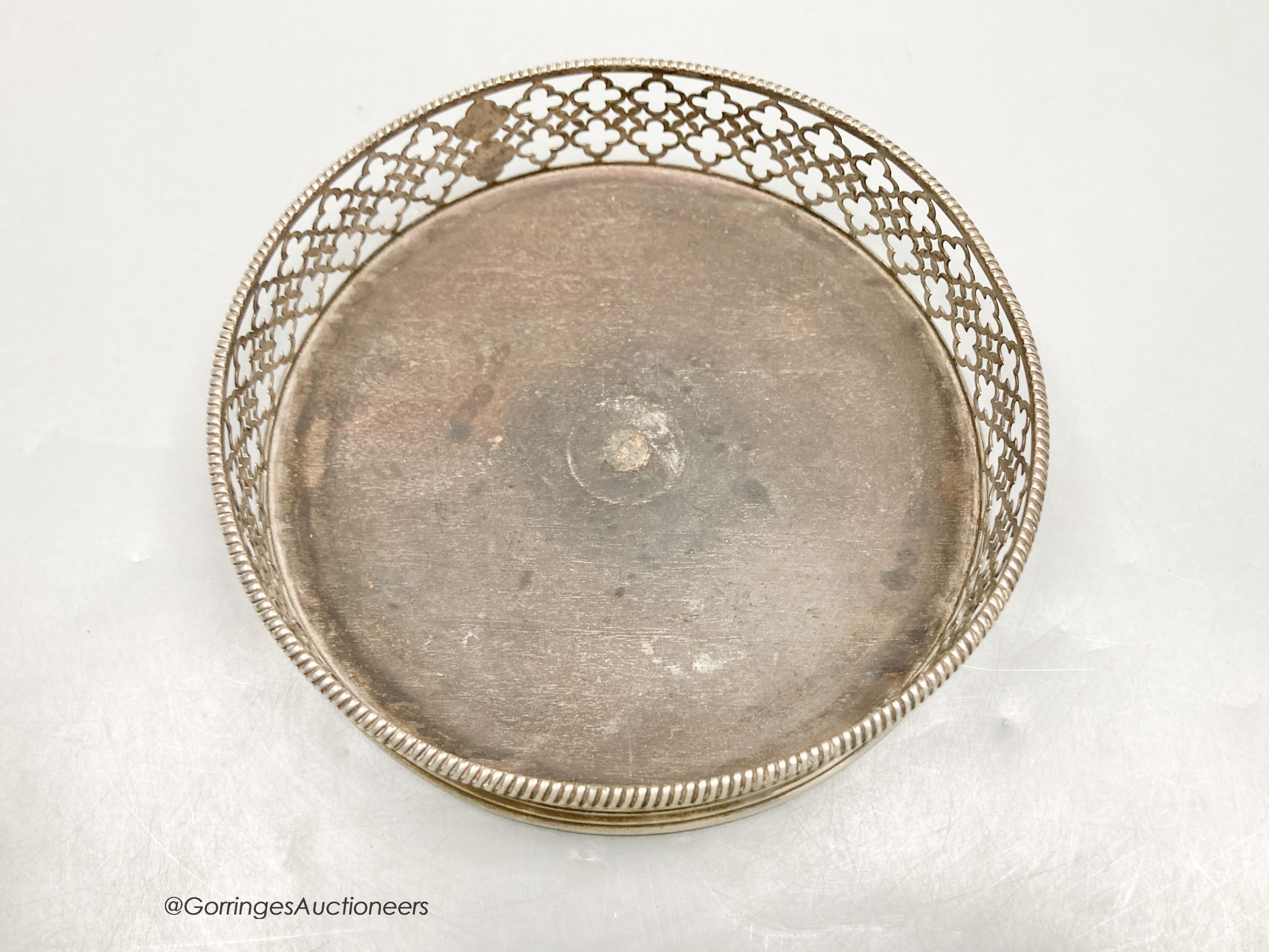 A George III pierced silver mounted wine coaster, Edward Lowe, London, 1775, with engraved initial, diameter 14.2cm.